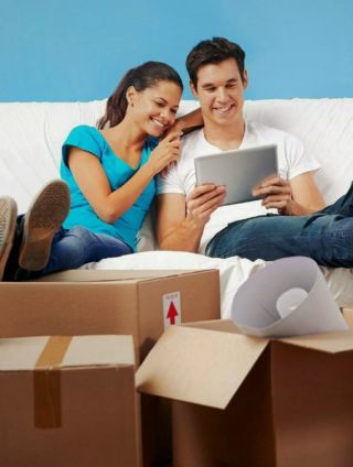 Image of a couple sitting on a sofa with a tablet computer