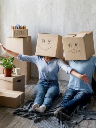 Image of two people with smiley face boxes on their heads