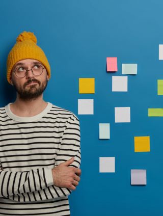 Image of a man and post it notes on a wall